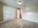 Well-lit bedroom featuring tile flooring, closet space and neutral color scheme at 898 Hendry Dr, Orlando, FL 32822