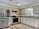 Well-lit kitchen featuring stainless steel appliances, granite countertops and ample cabinetry at 898 Hendry Dr, Orlando, FL 32822