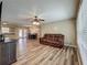 Spacious living room features hardwood floors, a ceiling fan, with view of kitchen and dining at 898 Hendry Dr, Orlando, FL 32822