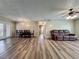Spacious living area featuring hardwood floors, ceiling fan, and access to the dining room at 898 Hendry Dr, Orlando, FL 32822