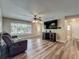 Bright living room with hardwood floors and open floorplan and entertainment center at 898 Hendry Dr, Orlando, FL 32822