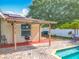 This brick paved patio features a covered area for seating and an outdoor tv for entertainment at 898 Hendry Dr, Orlando, FL 32822