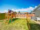 Wooden backyard playset offers a swing and fort with a grassy lawn perfect for playing at 898 Hendry Dr, Orlando, FL 32822
