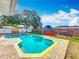 Backyard pool with a brick-trimmed jacuzzi, pergola, and lush landscaping at 898 Hendry Dr, Orlando, FL 32822