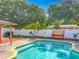 The backyard features a large pool with ample seating space along the perimeter for relaxing outdoors at 898 Hendry Dr, Orlando, FL 32822