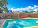 Backyard pool offers refreshing fun with lounge chairs, barbecue, and privacy fence at 898 Hendry Dr, Orlando, FL 32822