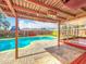 Backyard pool area with a pergola, landscaping, and fencing at 898 Hendry Dr, Orlando, FL 32822