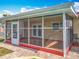 Enclosed and screened in back porch features plenty of space for seating and relaxing with Gathering at 898 Hendry Dr, Orlando, FL 32822