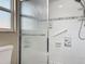 Close-up of shower with safety bar, patterned tile, and showerhead at 898 Hendry Dr, Orlando, FL 32822