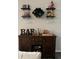 Stylish bar setup with decorative displays and storage for glasses and liquors, perfect for entertaining at 9028 Se 41St Court Rd, Ocala, FL 34480