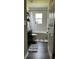 Bathroom features a dark vanity, toilet, shower/tub combo, and decorative shelves at 9028 Se 41St Court Rd, Ocala, FL 34480