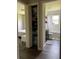 Bathroom features a dark vanity, toilet, shower/tub combo, and decorative shelves at 9028 Se 41St Court Rd, Ocala, FL 34480