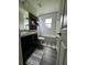 Bathroom features a dark vanity, toilet, shower/tub combo, and decorative shelves at 9028 Se 41St Court Rd, Ocala, FL 34480