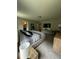 Bright bedroom featuring a king bed, carpeted floors, and a wall-mounted TV at 9028 Se 41St Court Rd, Ocala, FL 34480