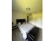 Bright bedroom featuring a black bed frame, closet, and black storage bench at 9028 Se 41St Court Rd, Ocala, FL 34480