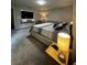 Bright bedroom featuring a king bed, carpeted floors, and a wall-mounted TV at 9028 Se 41St Court Rd, Ocala, FL 34480