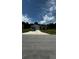 Charming single-story home with a well-manicured lawn and a paved driveway leading to an attached garage at 9028 Se 41St Court Rd, Ocala, FL 34480