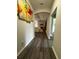Hallway with dark wood floors leading to an open concept living area with modern decor at 9028 Se 41St Court Rd, Ocala, FL 34480