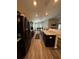 Modern kitchen with dark cabinetry, stainless steel appliances, large island, and open layout to the living areas at 9028 Se 41St Court Rd, Ocala, FL 34480