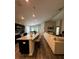 Bright open-concept living space with kitchen island, modern appliances, and comfortable seating area at 9028 Se 41St Court Rd, Ocala, FL 34480