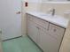 A remodeled bathroom with updated vanity, fixtures and green tiled flooring at 936 Pinedale Ave, Orlando, FL 32808