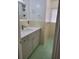 Well-lit bathroom featuring a modern vanity, updated fixtures, and retro tiled walls at 936 Pinedale Ave, Orlando, FL 32808