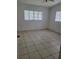 Clean bedroom with tiled floors, with natural light from multiple windows creating a pleasant space at 936 Pinedale Ave, Orlando, FL 32808