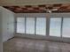 Bright sunroom with a decorative ceiling, tile floor, and large windows, perfect for relaxing at 936 Pinedale Ave, Orlando, FL 32808