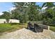 This brick patio in the backyard features outdoor seating and a view of the green space at 6768 Coral Berry Dr, Mount Dora, FL 32757