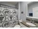 Bathroom featuring patterned shower curtain, granite countertop, and stylish fixtures at 6768 Coral Berry Dr, Mount Dora, FL 32757