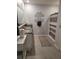 Bathroom with double vanity sink, gray tile floor, decorative wall decal, and patterned shower curtain at 6768 Coral Berry Dr, Mount Dora, FL 32757