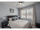 This bedroom features wood floors, a ceiling fan, and a window with natural light at 6768 Coral Berry Dr, Mount Dora, FL 32757