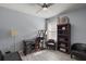 Spare bedroom features a desk, chair, bookshelf and a comfortable leather couch at 6768 Coral Berry Dr, Mount Dora, FL 32757