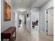 Bright hallway featuring neutral walls, tile flooring, and access to various rooms in the home at 6768 Coral Berry Dr, Mount Dora, FL 32757