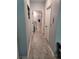 Hallway featuring gray tiling and access to the bathroom, bedrooms, and other rooms at 6768 Coral Berry Dr, Mount Dora, FL 32757
