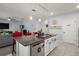 Bright kitchen showcasing an island with a dishwasher, granite countertop, and pendant lighting at 6768 Coral Berry Dr, Mount Dora, FL 32757