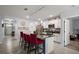 Well-lit kitchen featuring a large island, white cabinets and modern appliances at 6768 Coral Berry Dr, Mount Dora, FL 32757