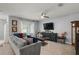 Comfortable living room features a large television, fan, and neutral color palette at 6768 Coral Berry Dr, Mount Dora, FL 32757