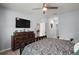 Spacious main bedroom showcases a dresser and a glimpse into the kitchen and hallway at 6768 Coral Berry Dr, Mount Dora, FL 32757