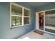 This patio has a window and sliding glass door leading to a dining room at 6768 Coral Berry Dr, Mount Dora, FL 32757