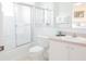 Clean bathroom with tile shower, toilet, vanity, and framed mirror; bright, light, and airy at 1000 Park Club Dr, Kissimmee, FL 34746