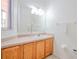 Well-lit bathroom with vanity, large mirror, and towel racks at 1000 Park Club Dr, Kissimmee, FL 34746