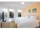 Cozy bedroom with two windows and queen-sized bed, along with nightstands at 1000 Park Club Dr, Kissimmee, FL 34746