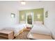 Bright bedroom featuring twin beds, wall sconces, and a window view at 1000 Park Club Dr, Kissimmee, FL 34746