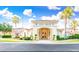 Beautiful clubhouse entrance with manicured landscaping and palm trees at 1000 Park Club Dr, Kissimmee, FL 34746