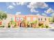 Colorful townhome featuring a tile roof, well-maintained landscaping, and parking at 1000 Park Club Dr, Kissimmee, FL 34746