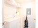 Clean laundry room featuring a washer, dryer, shelving and cleaning supplies at 1000 Park Club Dr, Kissimmee, FL 34746
