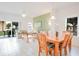 Living room and dining area with a patio sliding glass door and neutral tile flooring at 1000 Park Club Dr, Kissimmee, FL 34746