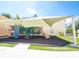 Fun playground area with slides and climbing structures, covered by a large awning to provide shade on sunny days at 1000 Park Club Dr, Kissimmee, FL 34746