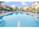 Resort-style pool with lounge chairs surrounded by lush landscaping and well-maintained buildings in a vibrant community at 1000 Park Club Dr, Kissimmee, FL 34746